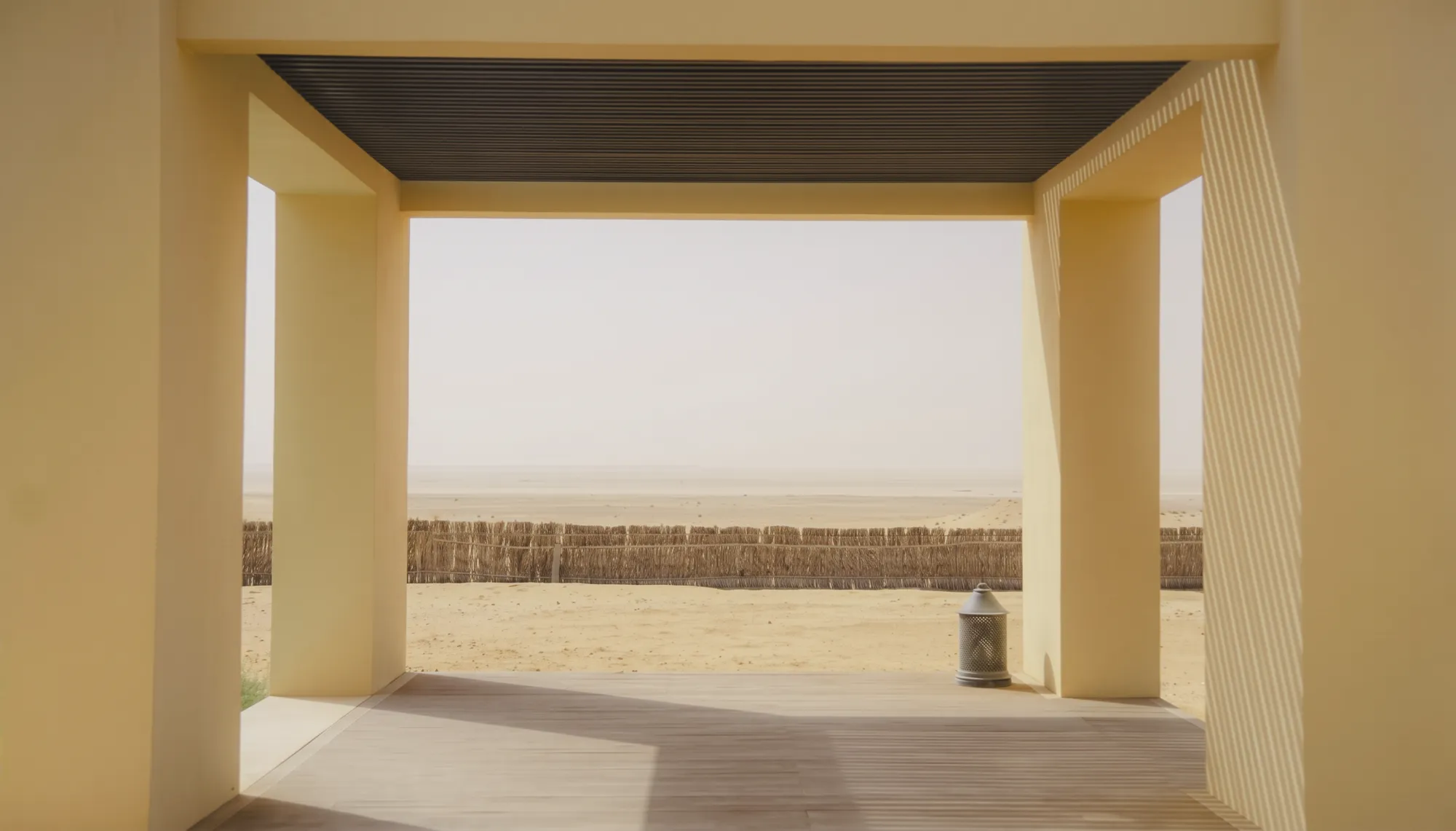 A shaded pavilion opening onto the desert