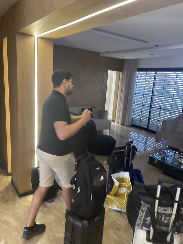 A teammate unpacking bags in a hotel room on arrival