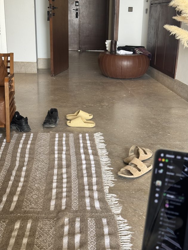 Shoes and slippers left by the door of a shared rental